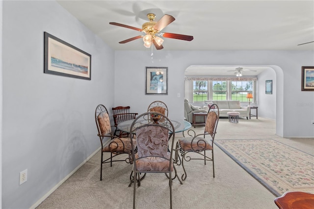 733 Ojai Ave, Sun City Center, FL 33573 - carpeted dining space with arched walkways and ceiling fan