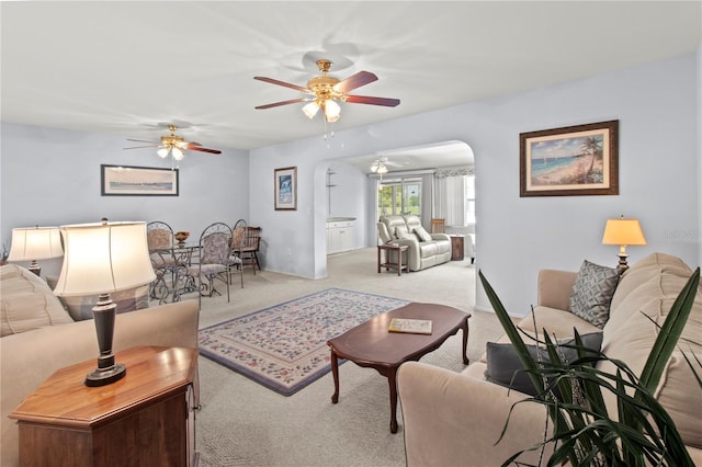 733 Ojai Ave, Sun City Center, FL 33573 - living room featuring carpet flooring, ceiling fan, and arched walkways