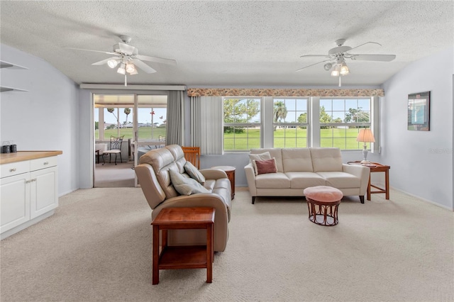 733 Ojai Ave, Sun City Center, FL 33573 - living room featuring a ceiling fan, light colored carpet, and a textured ceiling