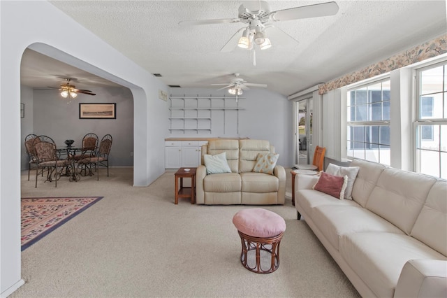 733 Ojai Ave, Sun City Center, FL 33573 - living area featuring arched walkways, carpet, a ceiling fan, and a textured ceiling