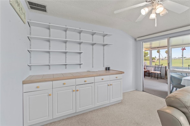 733 Ojai Ave, Sun City Center, FL 33573 - living area featuring light carpet, a textured ceiling, ceiling fan, and lofted ceiling