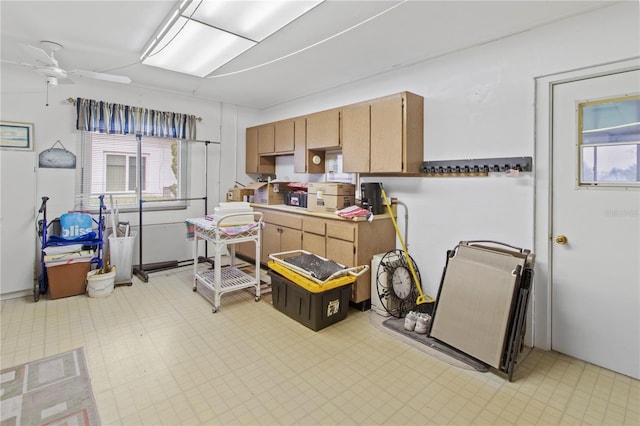 733 Ojai Ave, Sun City Center, FL 33573 - kitchen with a ceiling fan, light flooring, healthy amount of natural light, and light countertops