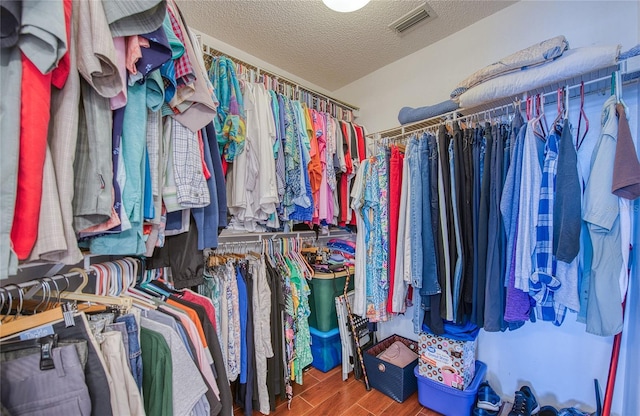 spacious closet featuring wood finished floors and visible vents