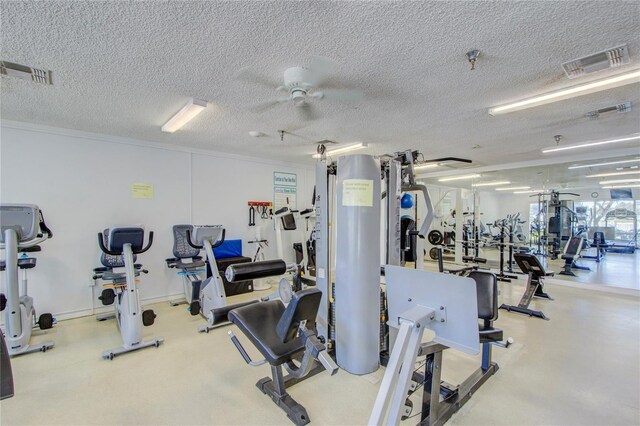 gym with visible vents, a textured ceiling, and ceiling fan