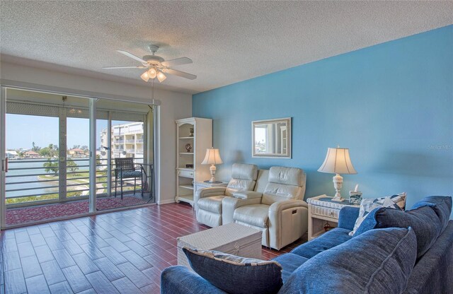 7872 Sailboat Key Blvd S Unit 404, South Pasadena, FL 33707 - living room featuring a ceiling fan, wood finished floors, a textured ceiling, and baseboards