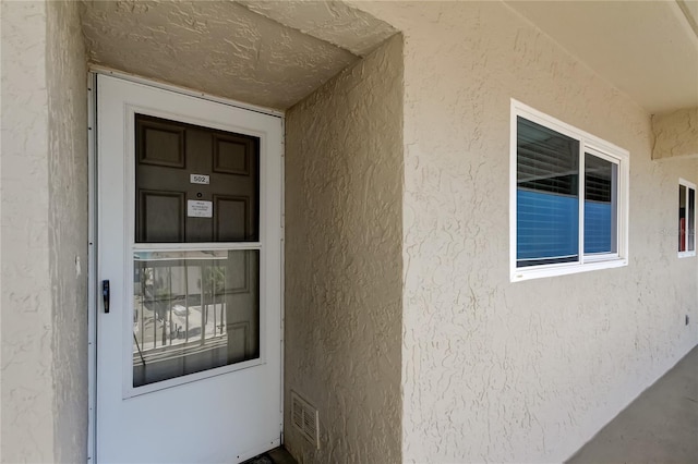 19925 Gulf Blvd Unit 502, Indian Shores, FL 33785 - property entrance with stucco siding and visible vents