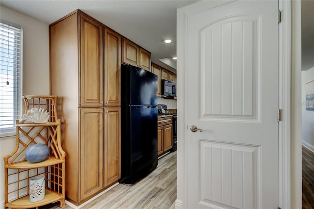 19925 Gulf Blvd Unit 502, Indian Shores, FL 33785 - kitchen featuring recessed lighting, brown cabinetry, black appliances, and light wood-type flooring