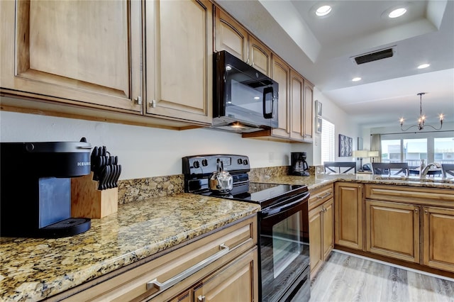 19925 Gulf Blvd Unit 502, Indian Shores, FL 33785 - kitchen featuring recessed lighting, a raised ceiling, a sink, visible vents, and black appliances