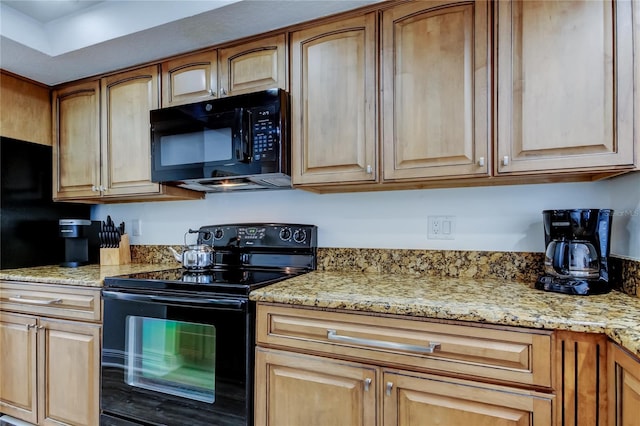 19925 Gulf Blvd Unit 502, Indian Shores, FL 33785 - kitchen with black appliances and light stone counters