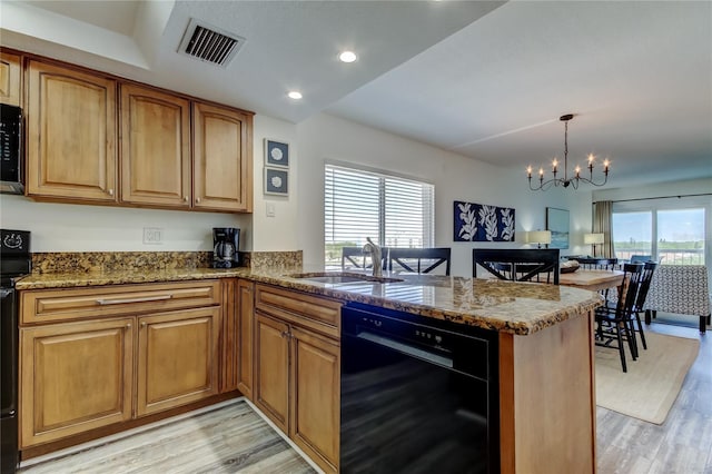 19925 Gulf Blvd Unit 502, Indian Shores, FL 33785 - kitchen featuring a sink, stone countertops, visible vents, black dishwasher, and a peninsula