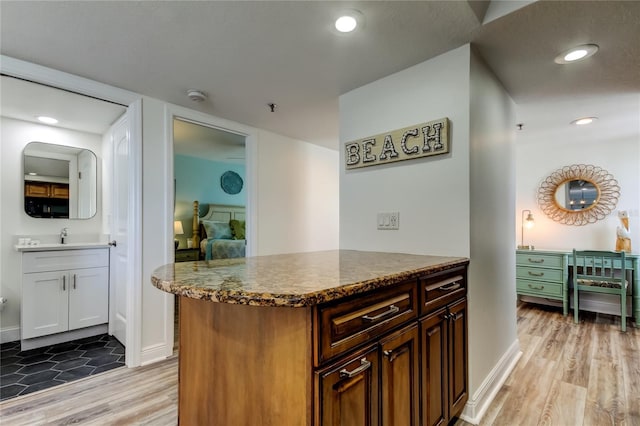 19925 Gulf Blvd Unit 502, Indian Shores, FL 33785 - kitchen with dark stone counters, baseboards, light wood-style floors, and recessed lighting