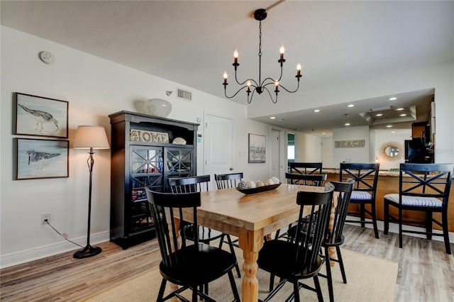 19925 Gulf Blvd Unit 502, Indian Shores, FL 33785 - dining area featuring baseboards, visible vents, light wood-style floors, and a chandelier