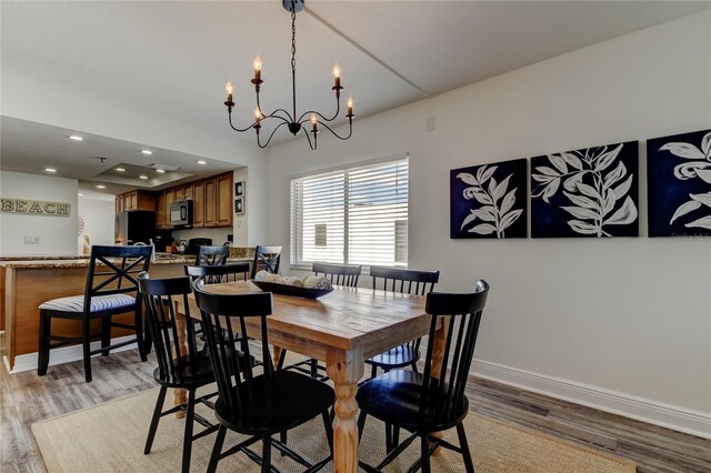 19925 Gulf Blvd Unit 502, Indian Shores, FL 33785 - dining room with baseboards, recessed lighting, an inviting chandelier, and light wood-style floors