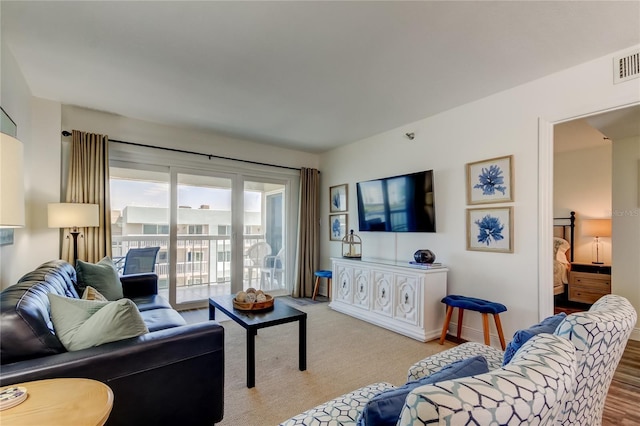 19925 Gulf Blvd Unit 502, Indian Shores, FL 33785 - living room featuring baseboards, visible vents, and wood finished floors