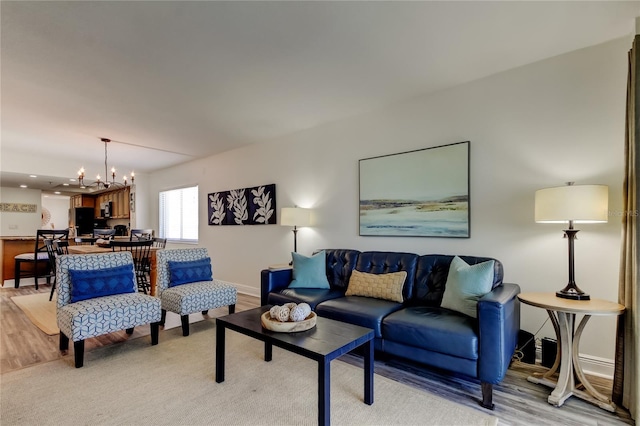 19925 Gulf Blvd Unit 502, Indian Shores, FL 33785 - living room featuring baseboards, light wood-type flooring, and a chandelier