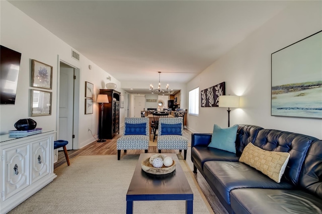 19925 Gulf Blvd Unit 502, Indian Shores, FL 33785 - living area with light wood finished floors, baseboards, a notable chandelier, and visible vents