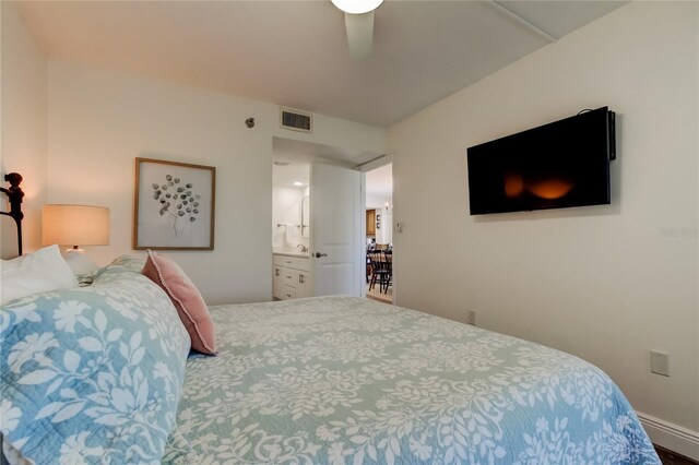 19925 Gulf Blvd Unit 502, Indian Shores, FL 33785 - bedroom featuring baseboards, connected bathroom, and visible vents