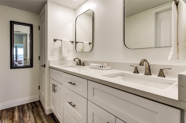 19925 Gulf Blvd Unit 502, Indian Shores, FL 33785 - full bathroom with baseboards, double vanity, a sink, and wood finished floors