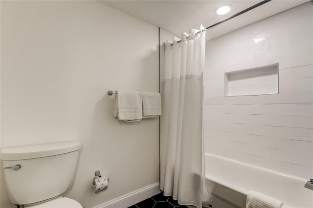 19925 Gulf Blvd Unit 502, Indian Shores, FL 33785 - bathroom featuring baseboards, shower / bath combo with shower curtain, toilet, and tile patterned floors