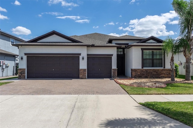 10008 Celtic Ash Dr, Ruskin, FL 33573 - view of front of property featuring stucco siding, decorative driveway, and stone siding