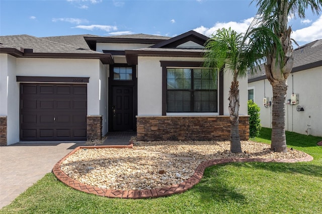 10008 Celtic Ash Dr, Ruskin, FL 33573 - view of front of property featuring a garage, driveway, stucco siding, stone siding, and a shingled roof