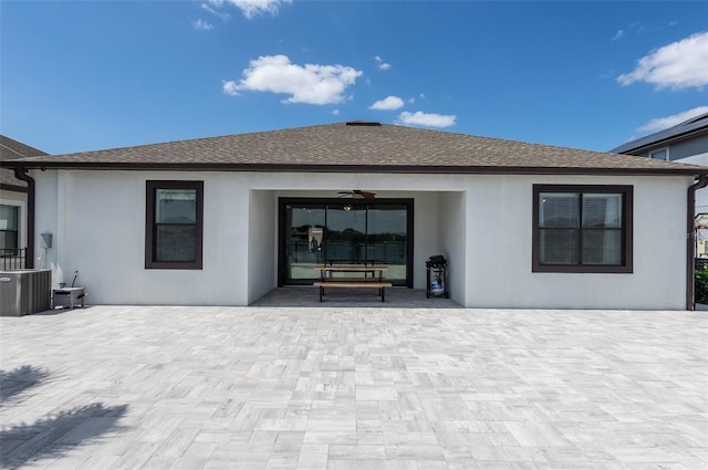 10008 Celtic Ash Dr, Ruskin, FL 33573 - back of house featuring stucco siding, ceiling fan, and roof with shingles