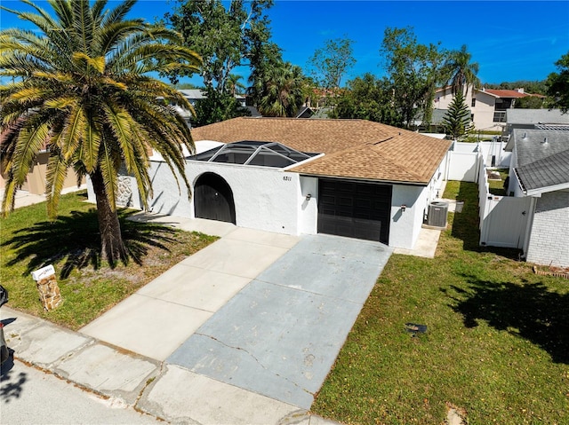 ranch-style home featuring a gate, roof with shingles, concrete driveway, stucco siding, and fence