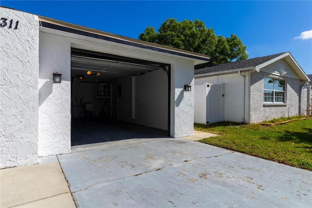 garage featuring concrete driveway