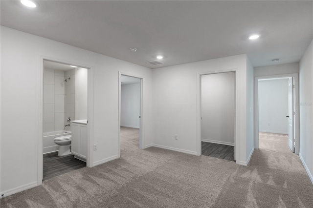 unfurnished bedroom featuring baseboards, visible vents, recessed lighting, and carpet flooring