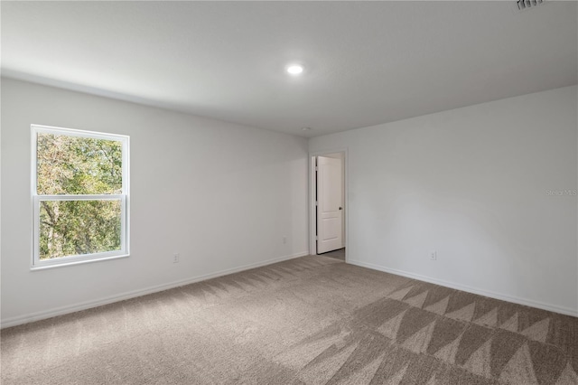 empty room featuring baseboards, carpet floors, and recessed lighting