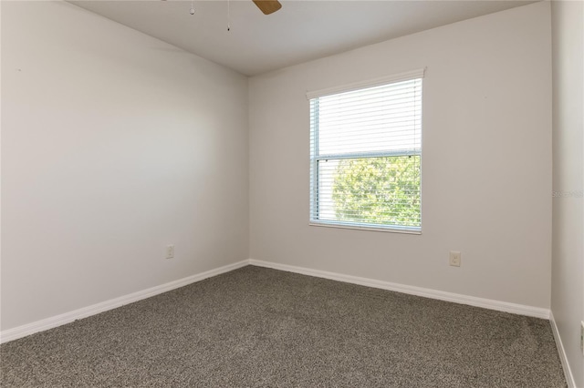 carpeted empty room with baseboards and ceiling fan
