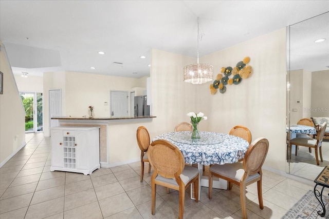 11260 Kapok Grand Cir, Madeira Beach, FL 33708 - dining space featuring recessed lighting, light tile patterned floors, baseboards, and an inviting chandelier