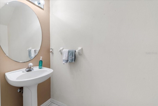11260 Kapok Grand Cir, Madeira Beach, FL 33708 - bathroom featuring baseboards