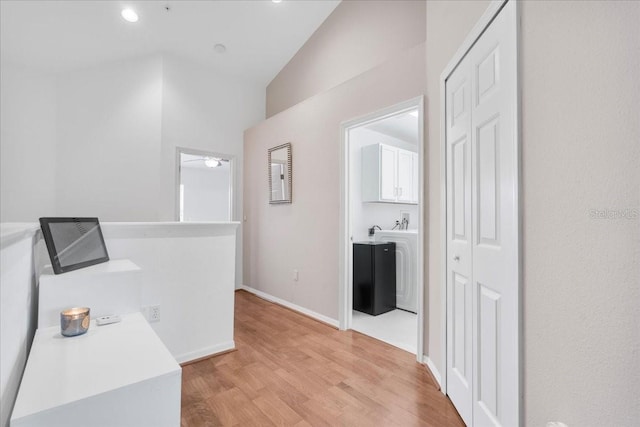 11260 Kapok Grand Cir, Madeira Beach, FL 33708 - hallway featuring light wood-type flooring and baseboards