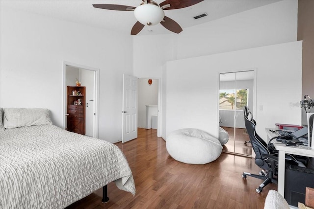 11260 Kapok Grand Cir, Madeira Beach, FL 33708 - bedroom with a towering ceiling, visible vents, ceiling fan, and wood finished floors