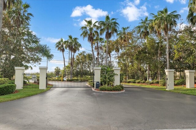 11260 Kapok Grand Cir, Madeira Beach, FL 33708 - view of gate featuring fence
