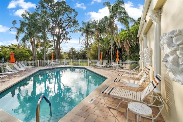 11260 Kapok Grand Cir, Madeira Beach, FL 33708 - community pool with a patio area and fence