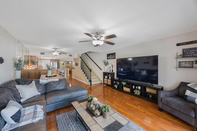14649 Seminole Trl Unit 5, Seminole, FL 33776 - living room featuring ceiling fan, stairs, and wood finished floors