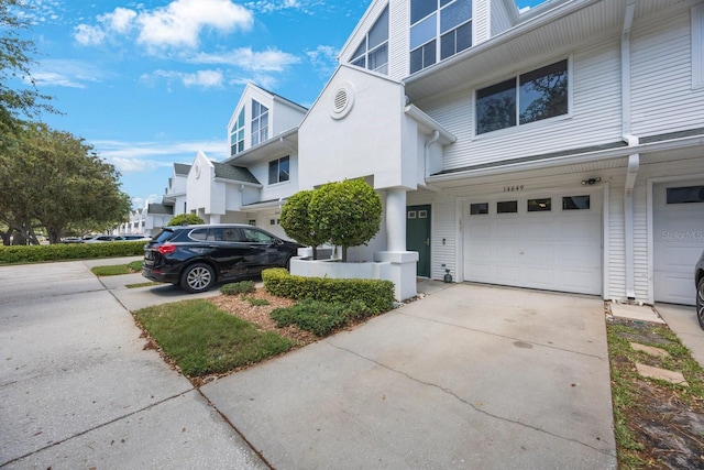 14649 Seminole Trl Unit 5, Seminole, FL 33776 - view of property exterior featuring a garage and concrete driveway