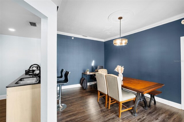 215 Central Ave Unit 4F, Saint Petersburg, FL 33701 - dining room with dark wood-type flooring, crown molding, baseboards, and visible vents