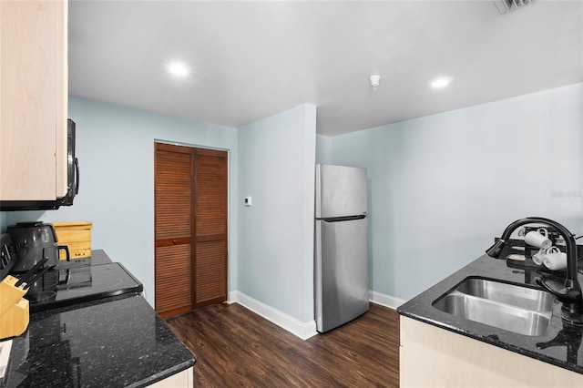 215 Central Ave Unit 4F, Saint Petersburg, FL 33701 - kitchen with freestanding refrigerator, dark stone countertops, a sink, baseboards, and dark wood-style floors