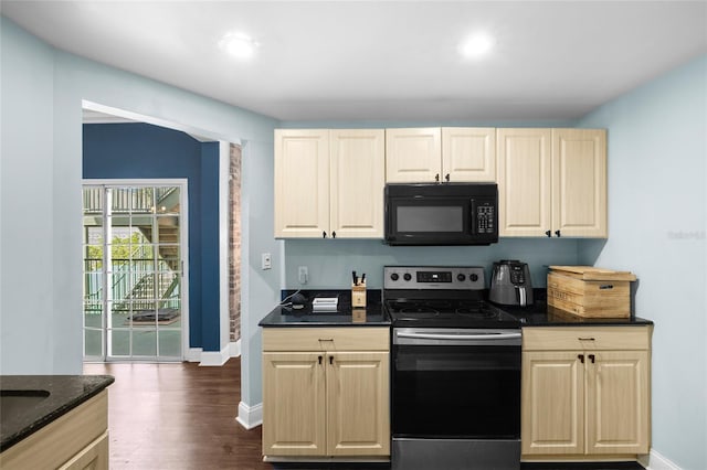 215 Central Ave Unit 4F, Saint Petersburg, FL 33701 - kitchen featuring baseboards, dark wood finished floors, black microwave, dark stone counters, and stainless steel electric range