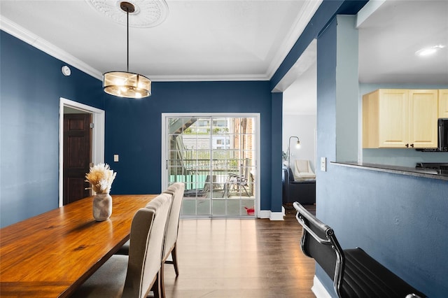 215 Central Ave Unit 4F, Saint Petersburg, FL 33701 - dining room with baseboards, crown molding, and wood finished floors