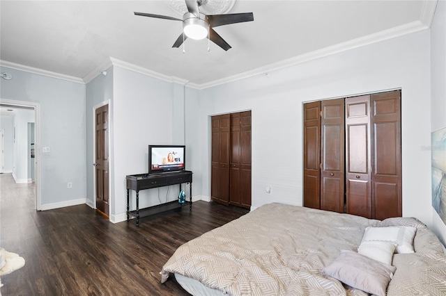 215 Central Ave Unit 4F, Saint Petersburg, FL 33701 - bedroom with crown molding, baseboards, dark wood-style floors, and multiple closets