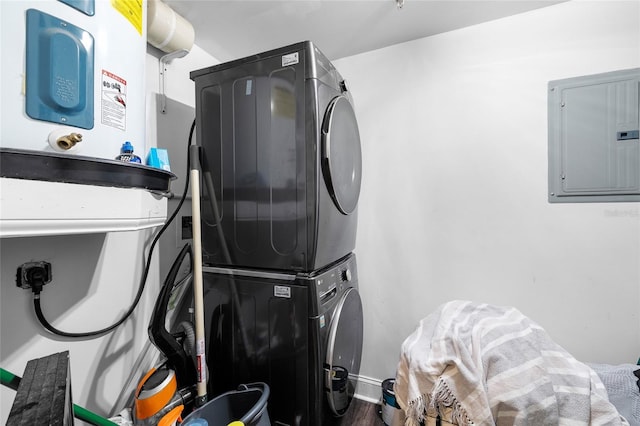 215 Central Ave Unit 4F, Saint Petersburg, FL 33701 - clothes washing area featuring electric panel, stacked washing maching and dryer, laundry area, and wood finished floors