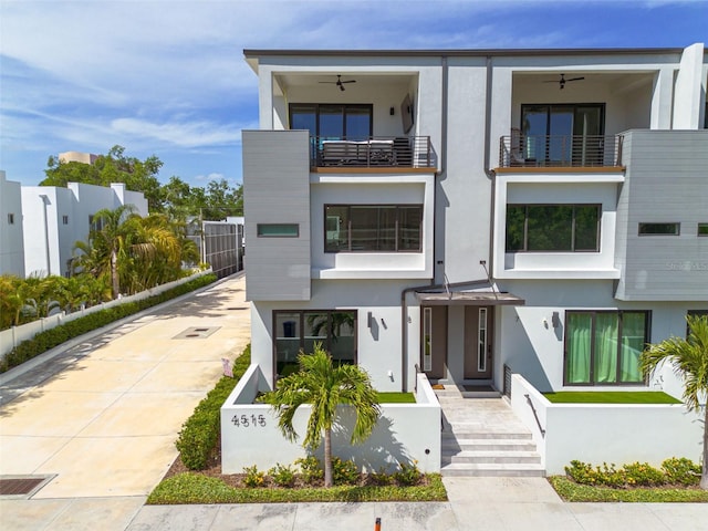 contemporary home featuring stucco siding and a balcony