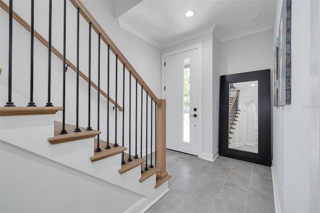 tiled foyer entrance featuring recessed lighting, baseboards, ornamental molding, and stairs