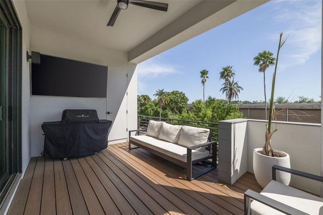 wooden terrace featuring ceiling fan and an outdoor hangout area