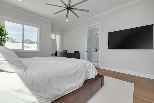 bedroom with recessed lighting, baseboards, ornamental molding, ensuite bath, and wood finished floors