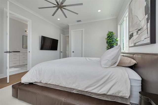 bedroom with connected bathroom, wood finished floors, visible vents, ornamental molding, and recessed lighting
